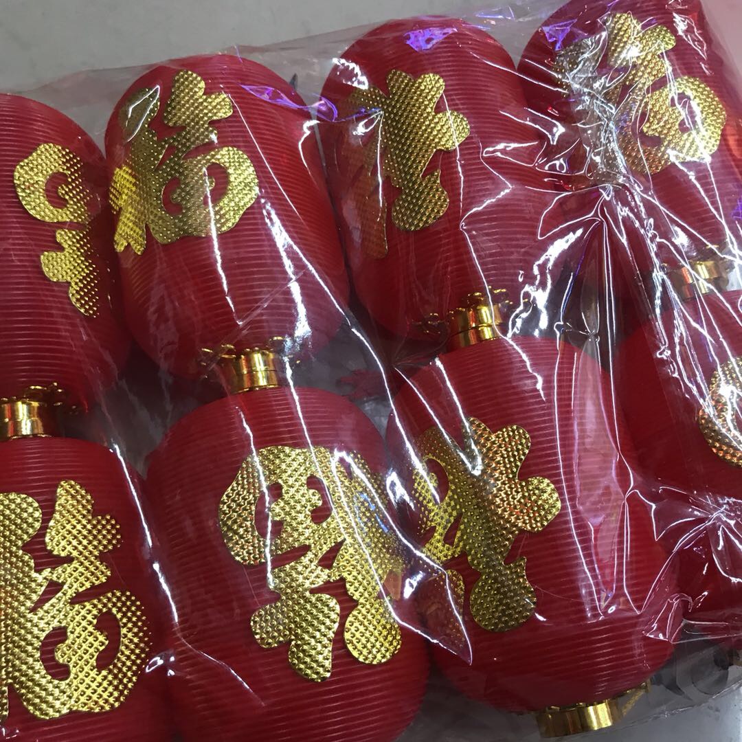 The oval-shaped long lantern has a golden "Fu" character printed on its surface and can be hung in a Chinese style Specification image