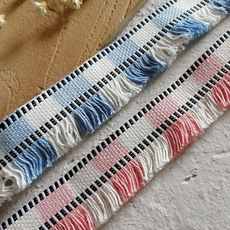 Lace trim, throw pillows, tassels, beards and checkered hem of the garment details Picture