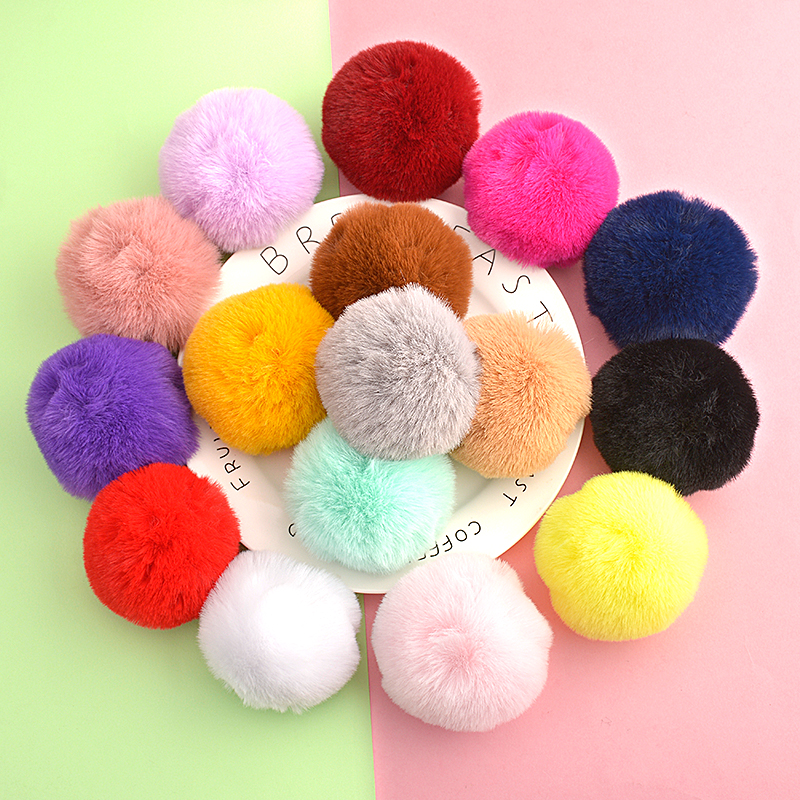 Close-up of golden handmade pom poms showing texture and craftsmanship