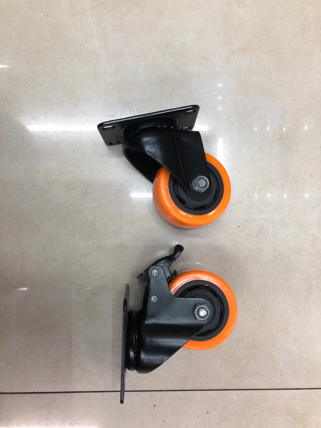 Medium-sized casters with perforated wheels, orange face and black core wheels Specification image