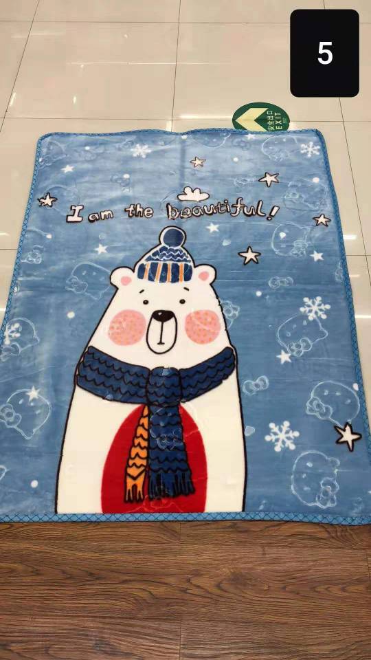 Child hugging cartoon cloud blanket before bedtime