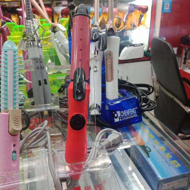 Straight bristle with a big red plug-in curling iron
