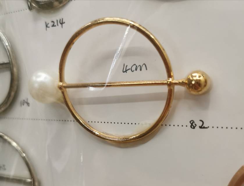 Close-up of the brooch showing the anti-slip mechanism and pearl detail