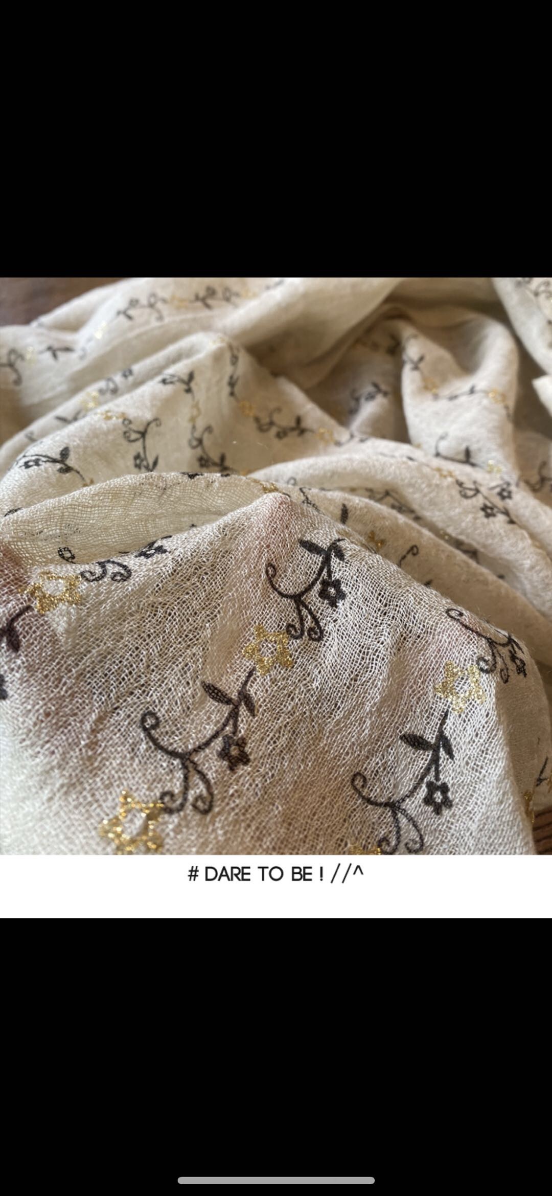Close-up of women wearing soft wool scarf in neutral tones