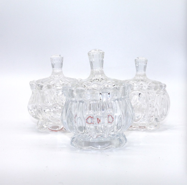 A transparent glass sugar jar with a lid