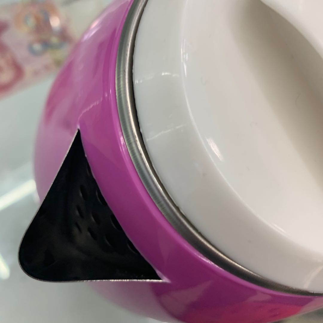 A pinkish-white water kettle for household use details Picture