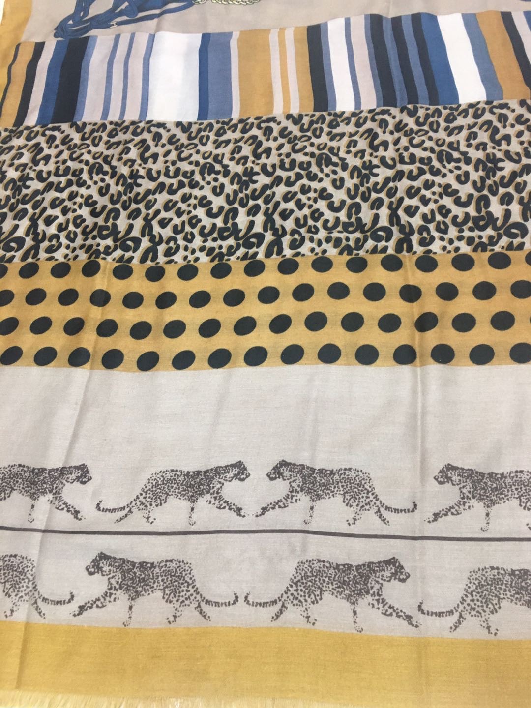 A trendy and popular women's scarf with thin satin polka dot leopard print details Picture