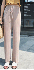 The 2020 new high-waisted, drape casual pants for both men and women are a simple solid color with a stretched-waist style