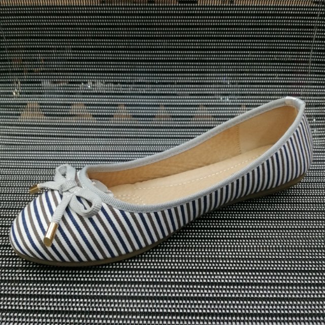 Side view of women's boat shoes showing horizontal two-color stripes and soft sole