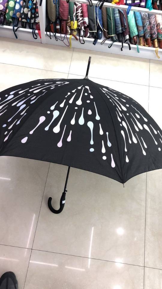 A long umbrella that changes color when exposed to water
