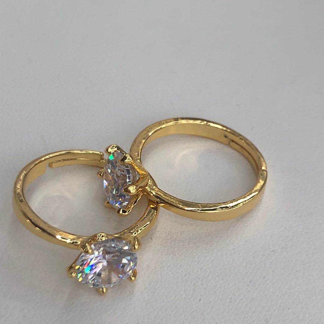 Stacked gold rings including the zircon ring for a layered look