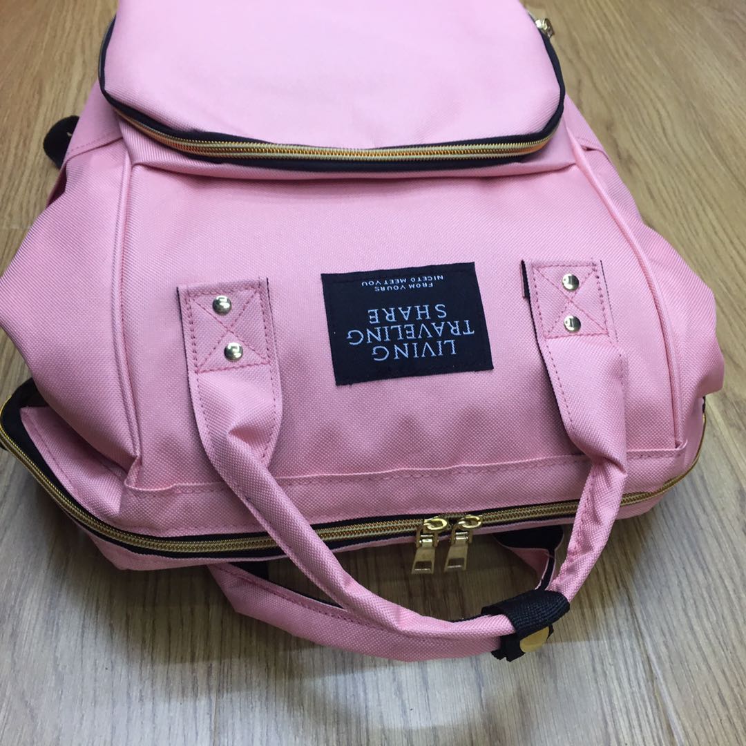 Photo of a model carrying a mommy bag in a park