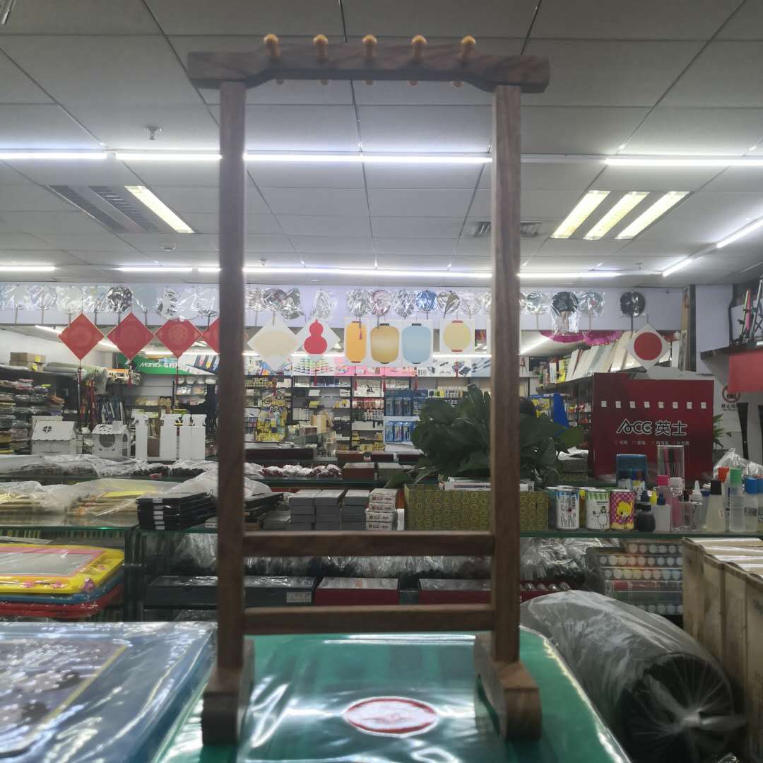 Ten Chinese-style wooden pen holders are hung full figure