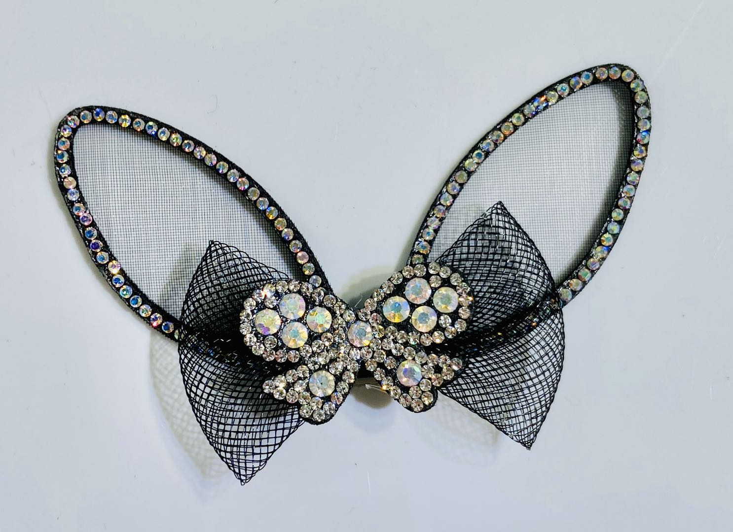 Close-up of rabbit ear bows used in various crafts: notebooks, bags, and gift wrapping
