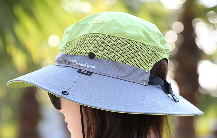Green Basin Sun Hat folded inside a backpack