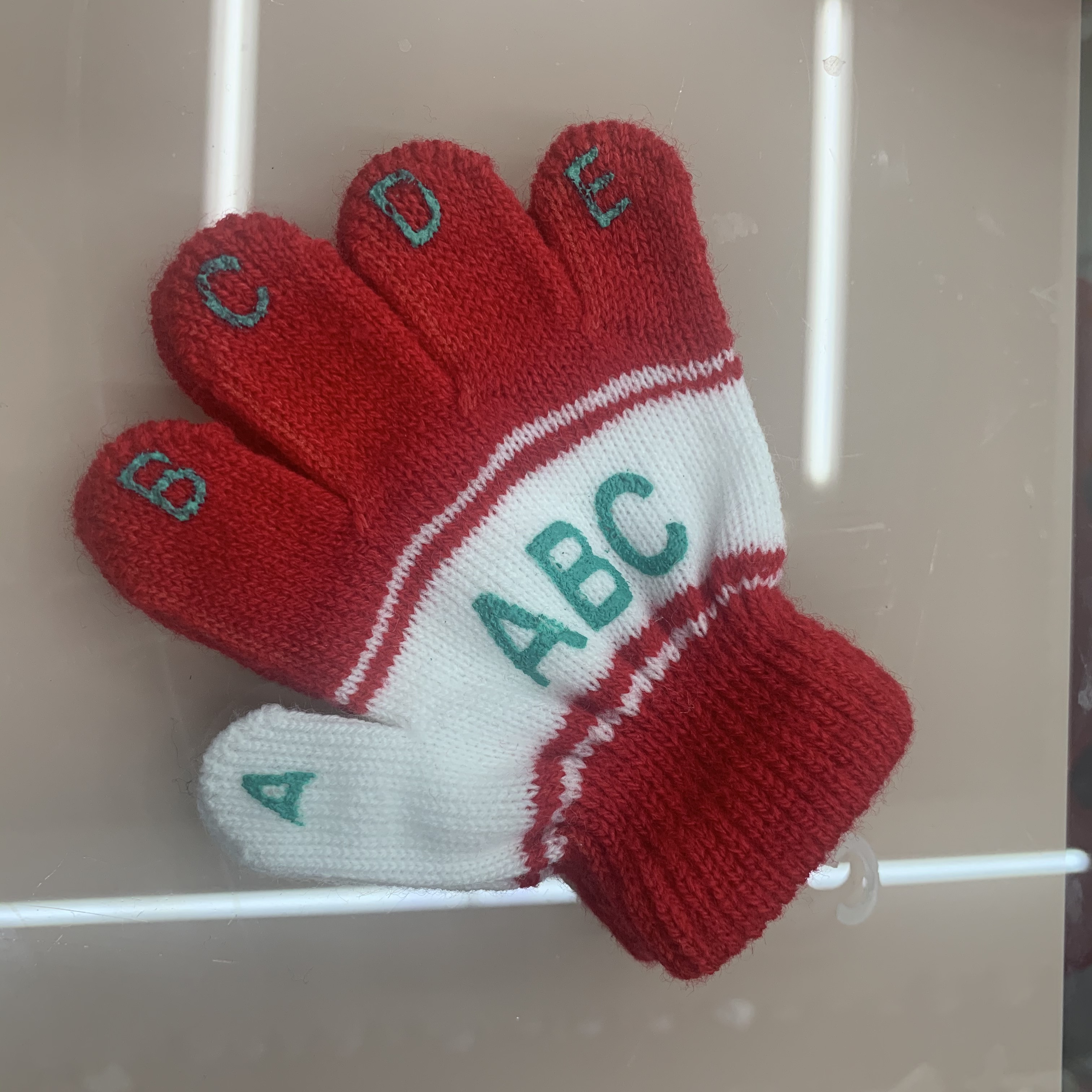 Children wearing soft and warm winter gloves in a snowy park
