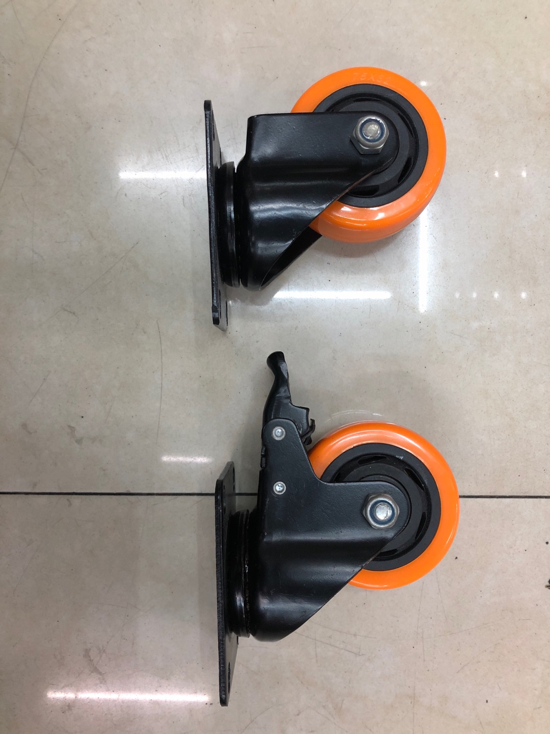 Medium-sized casters with perforated wheels, orange face and black core wheels
