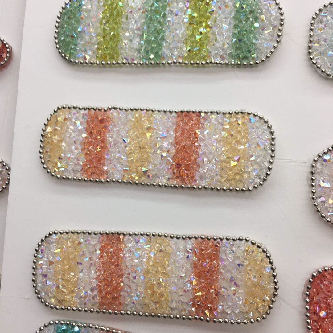 Child opening the DIY hair clip kit, hands reaching into colorful components like glitter powder and leather strips