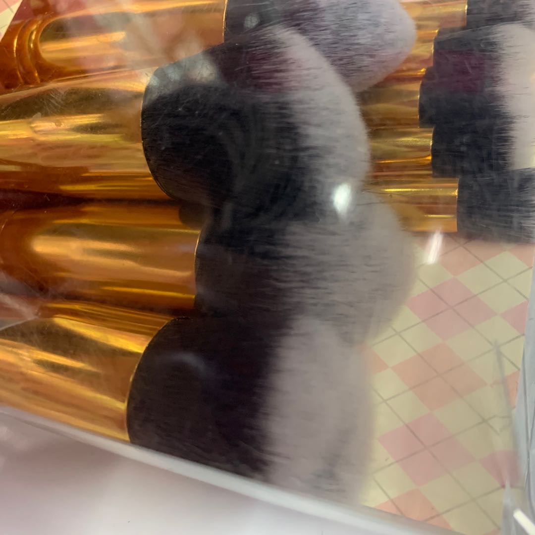 High-end makeup brush with foundation, gold edge and black and white bristles details Picture