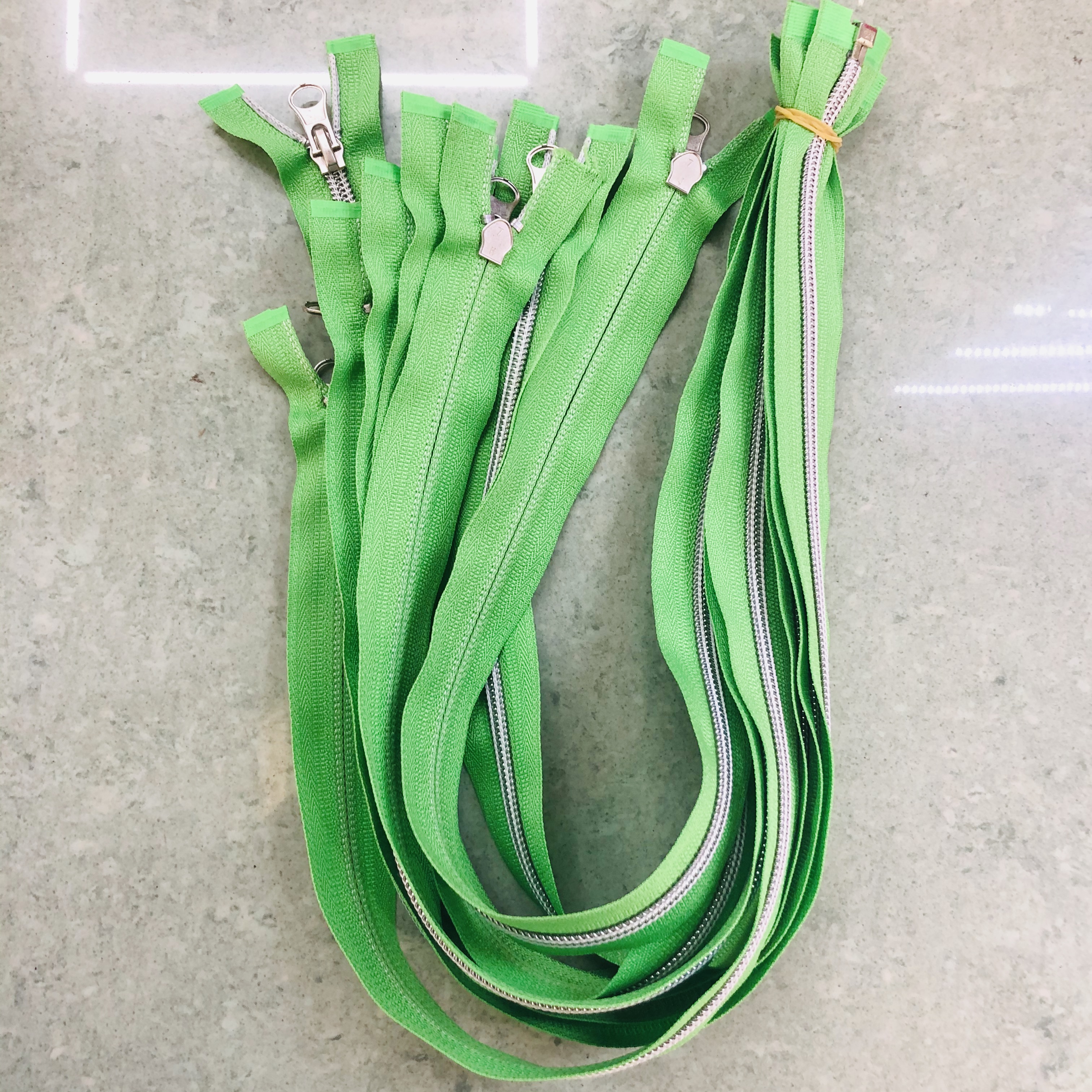 Eco-friendly 57 nylon zippers in multiple colors on fabric swatches