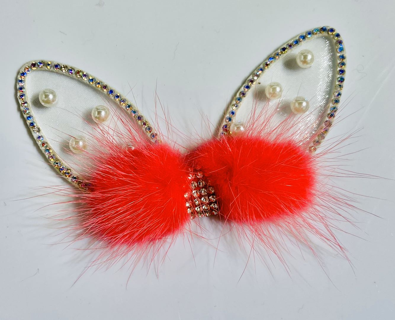 Assorted rabbit ear bow accessories in different colors and materials laid out artistically