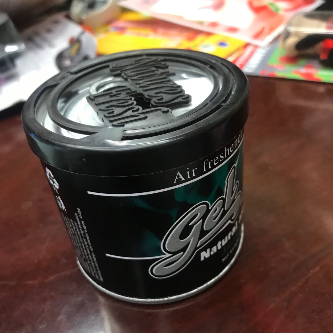 Close-up of solid balm fragrance in its compact tin container