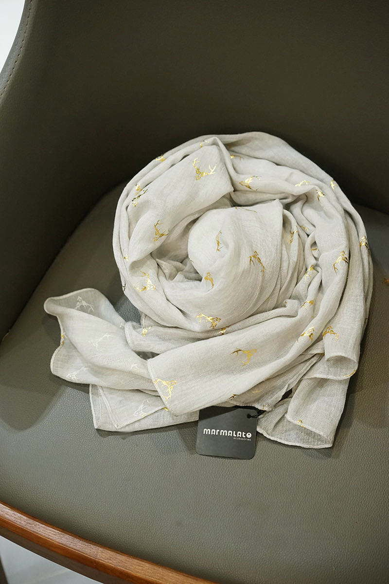 Close-up of gray scarf with cute antler pattern