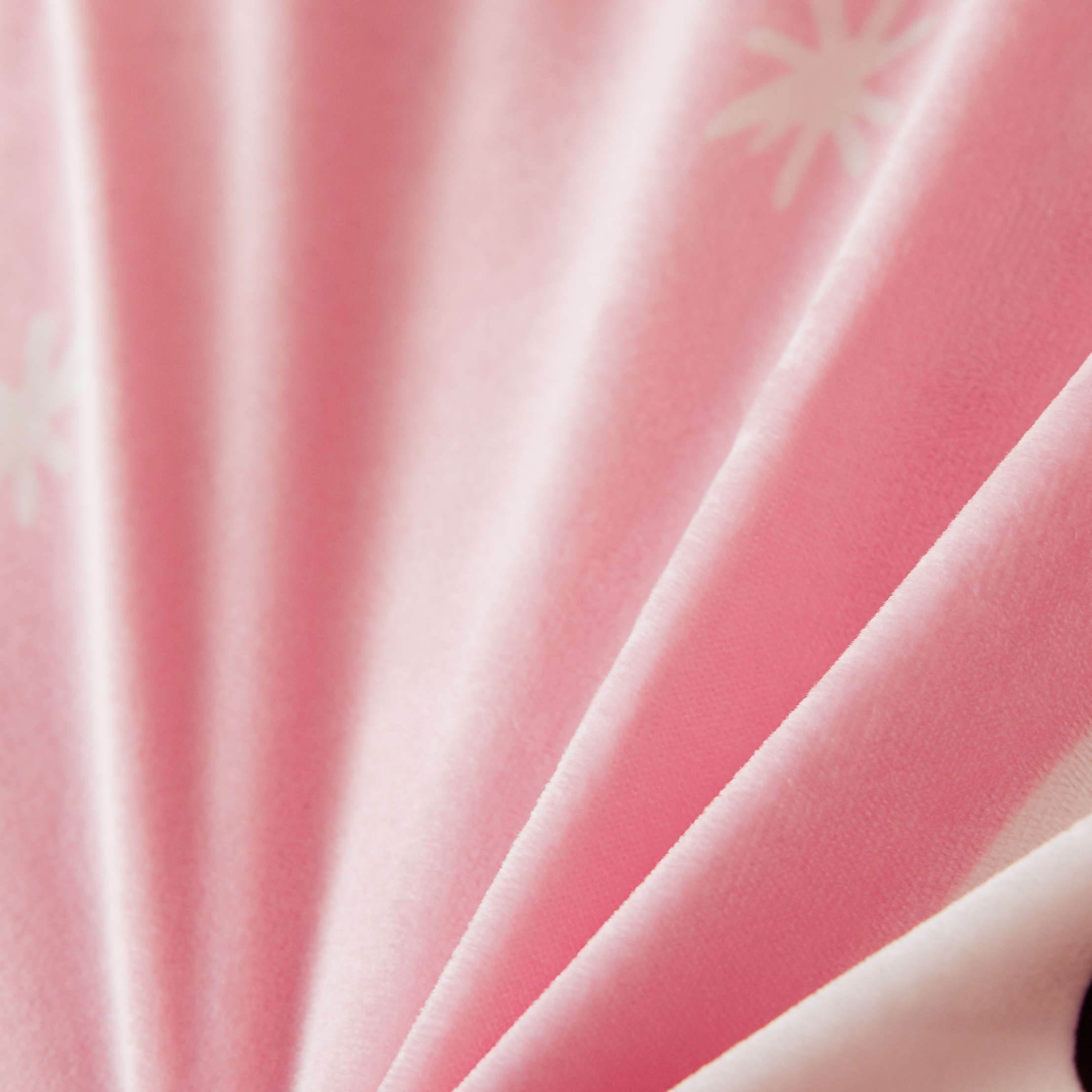 Close-up of rabbit pattern on pink coral velvet bedding