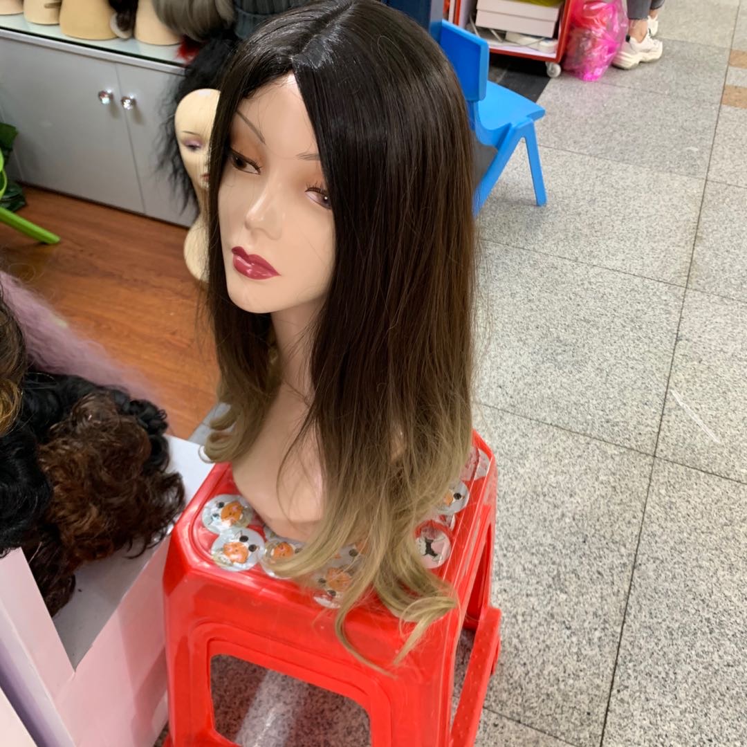 The popular female long curly wig is a realistic full head set with large waves and a middle parting details Picture