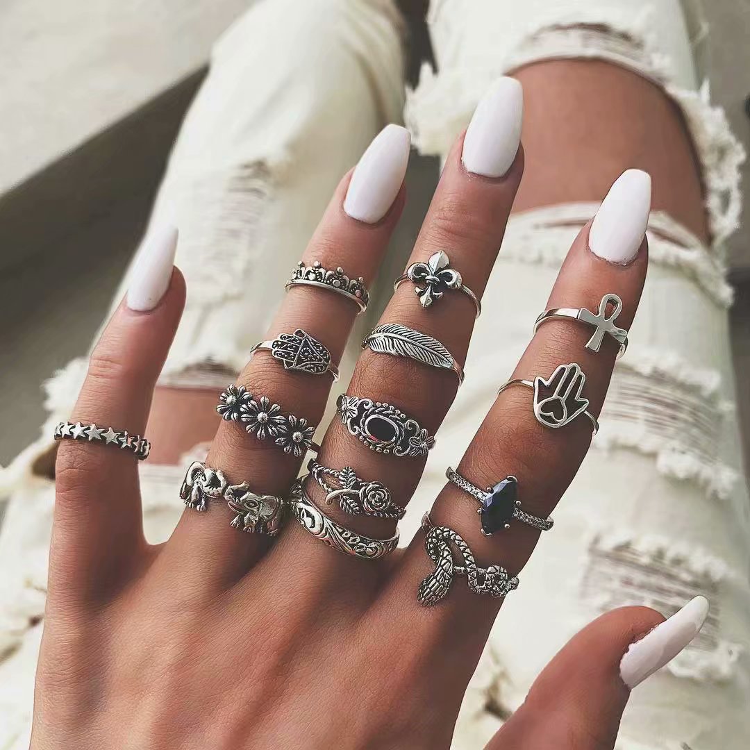 A collection of retro snake, elephant, rose, palm, leaf, silver and gold ring sets