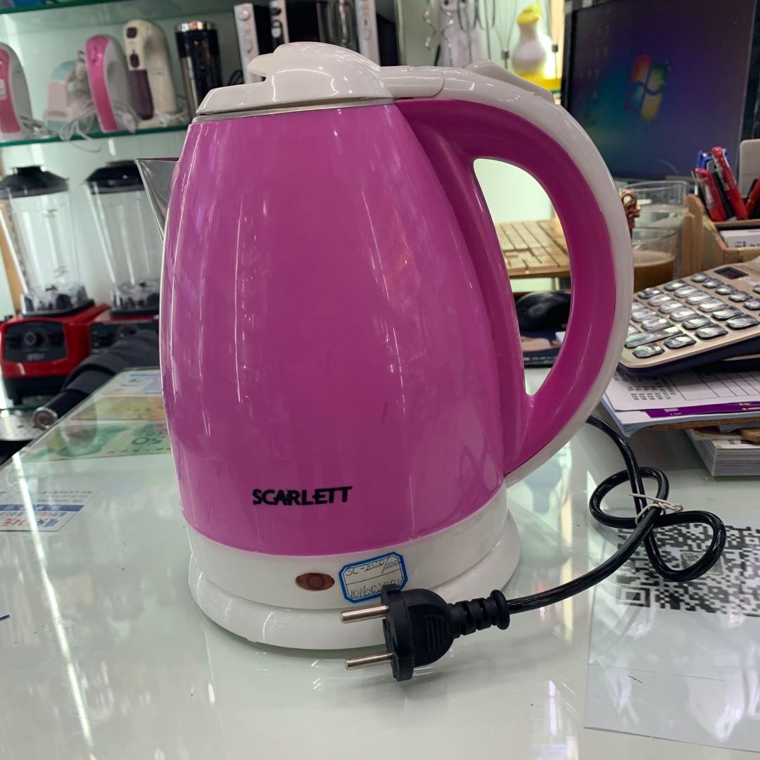 A pinkish-white water kettle for household use