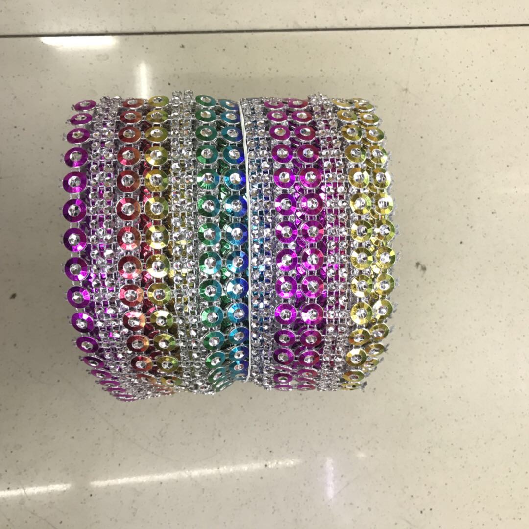 It is made of colored sequins and silver rhinestones as clothing accessories