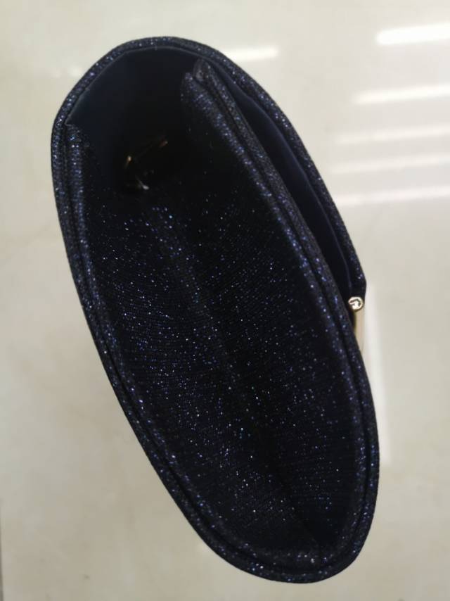 Close-up view of stylish crossbody banquet bag showing interior details and adjustable strap