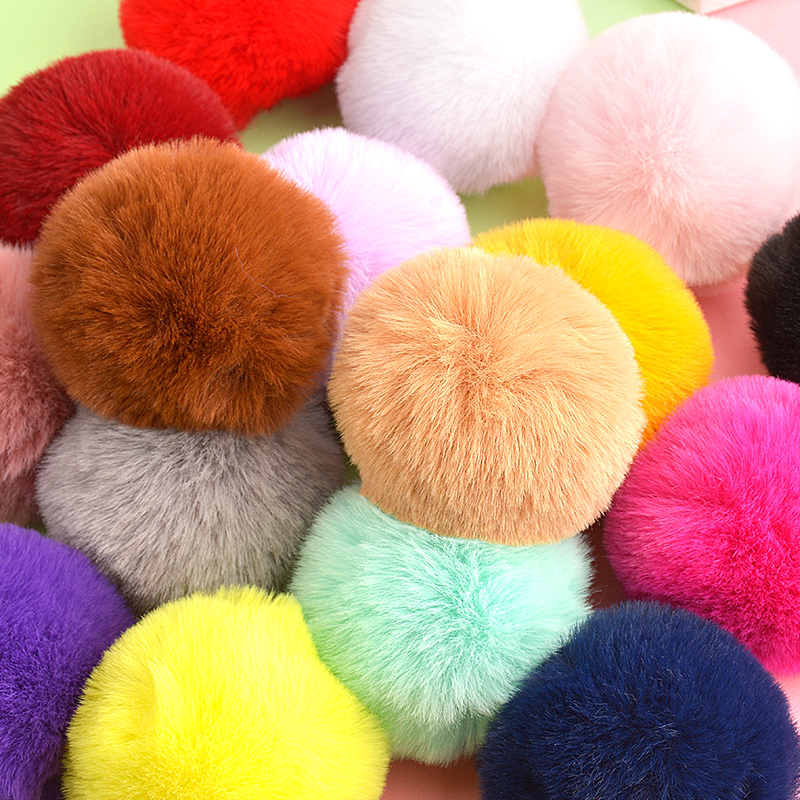 Children crafting with colorful pom poms in a classroom setting