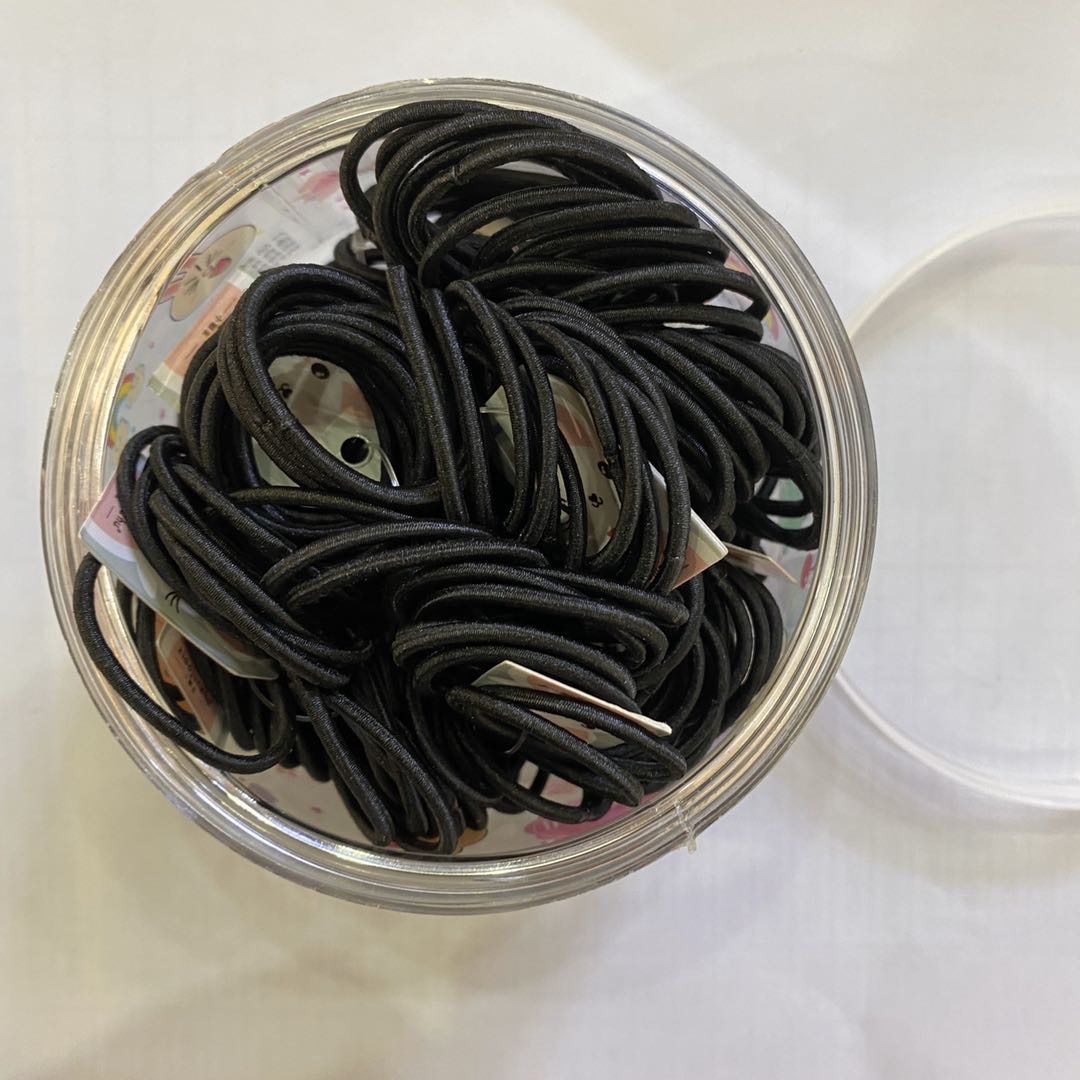 A simple and versatile black nylon headband in a box details Picture