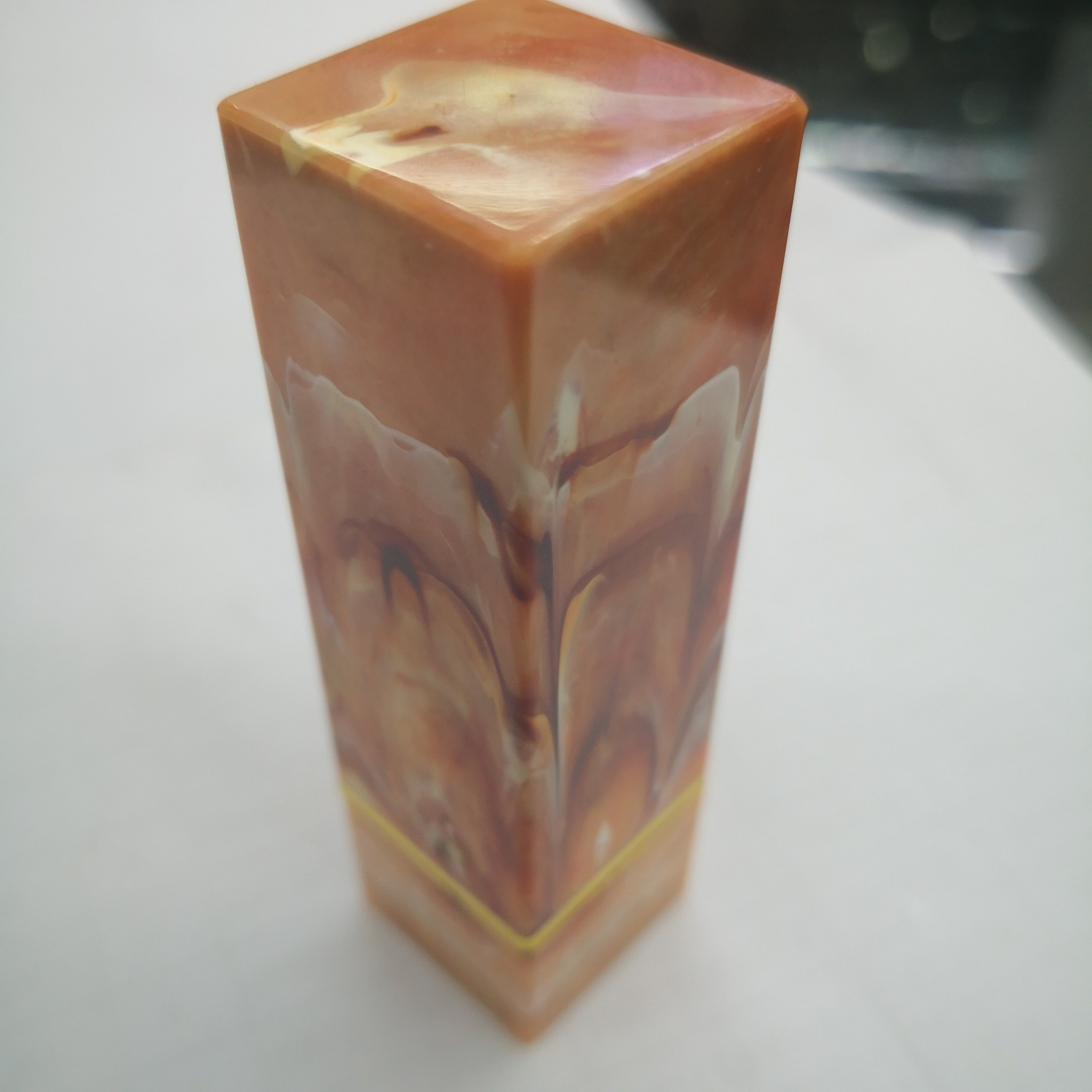 Close-up display of square jade lipstick case