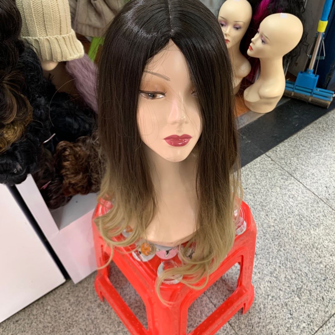 The popular female long curly wig is a realistic full head set with large waves and a middle parting