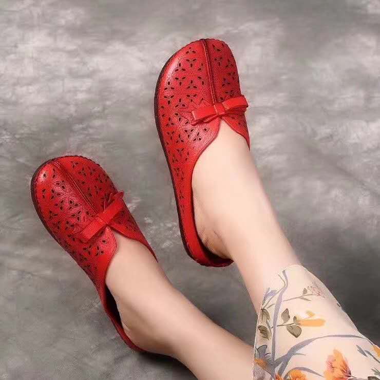 Close-up of ethnic pattern and hand-stitched leather details