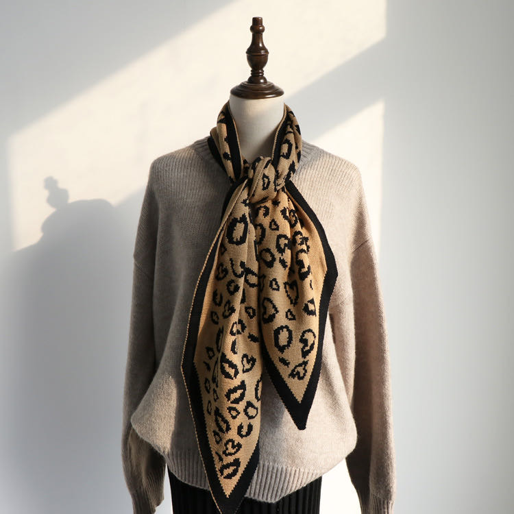 Leopard print women's scarf draped elegantly over a coat