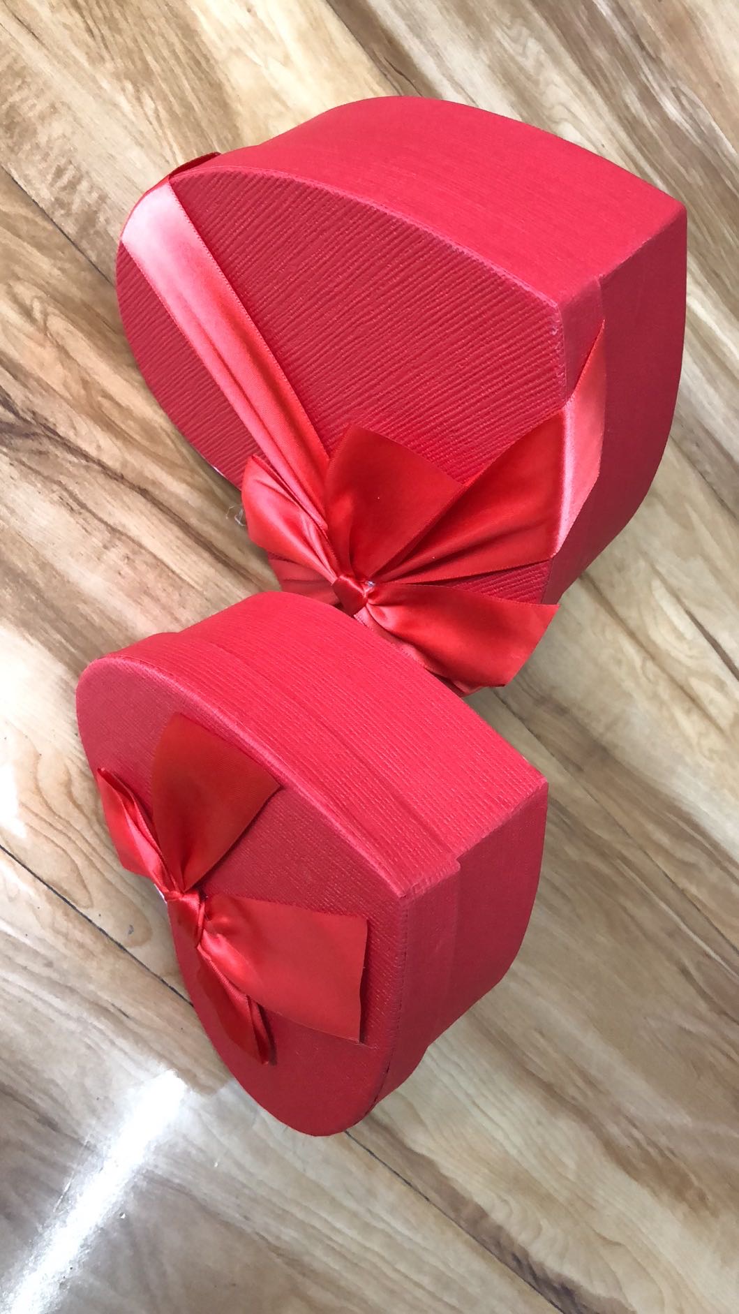 Open red heart-shaped gift box showing space for small gifts or decorations