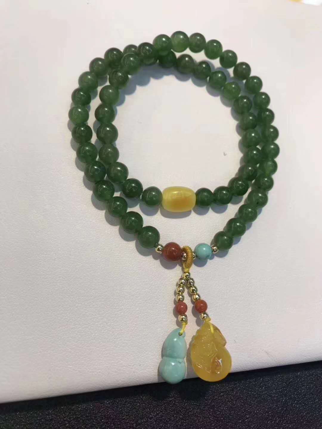 Close-up of Hetian Jasper beads showing natural wax finish
