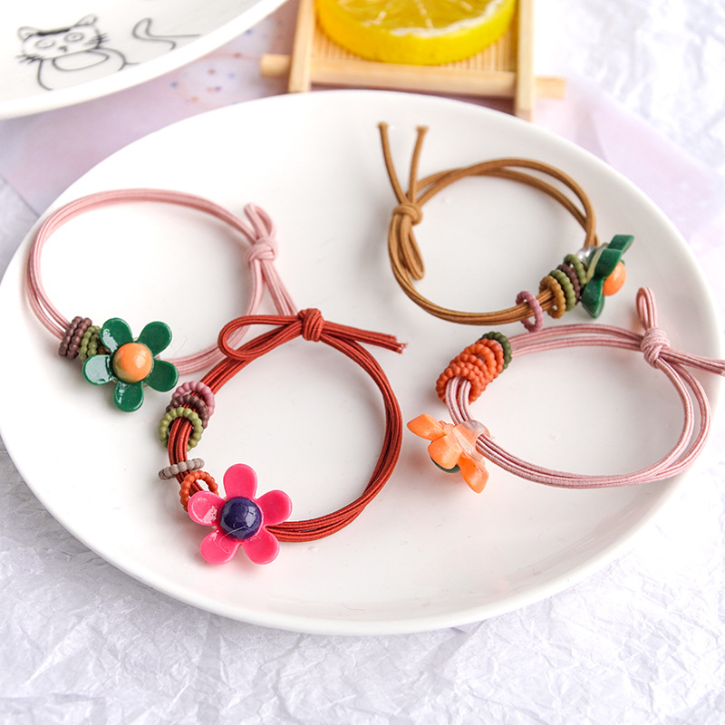 Factory direct sales of the popular new solid-color flower bow hair band in Korean style. Cute girls, elastic and won't damage hair
