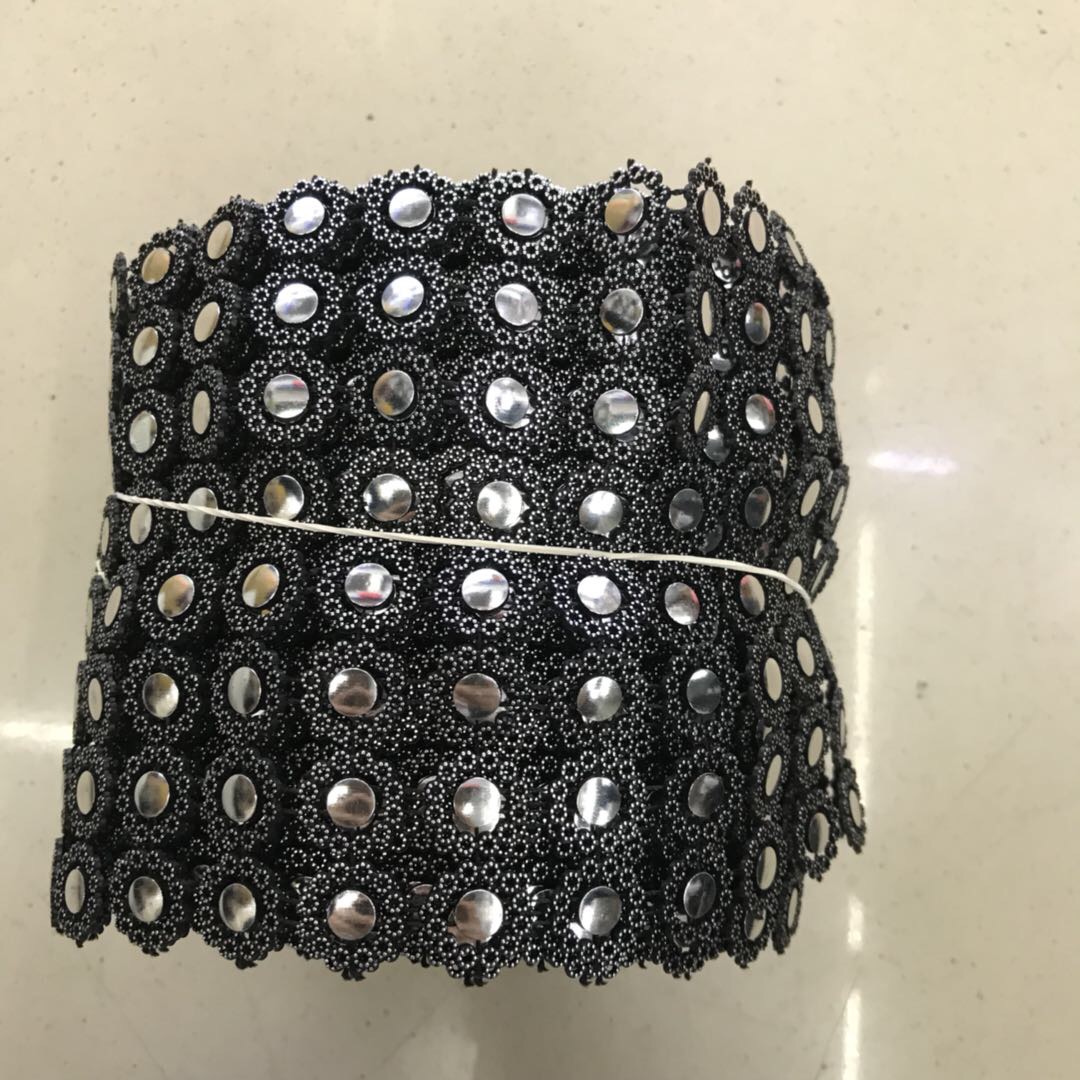The clothing accessories feature a black base with patterned sequins and silver rhinestone trim