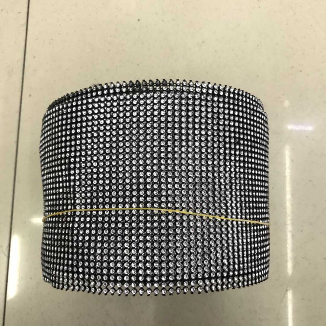 The clothing accessories are decorated with silver rhinestones and black mesh, with uniform cutting