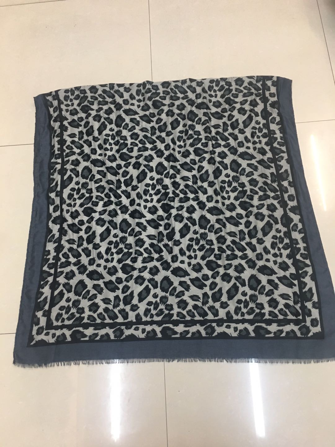 A trendy and popular women's scarf with a thin satin polka dot leopard print