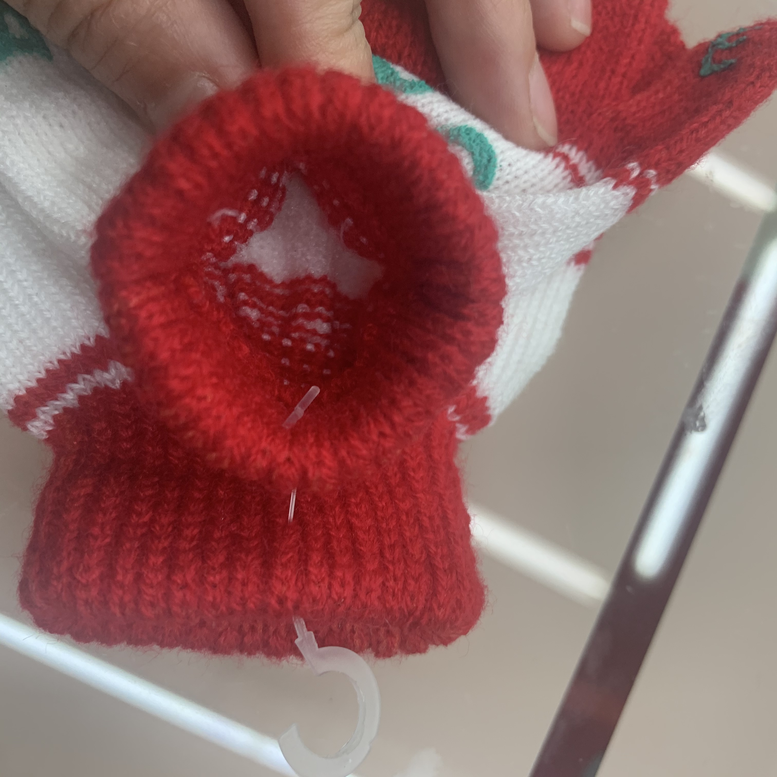 Assorted colors of children's winter gloves laid flat on wooden surface