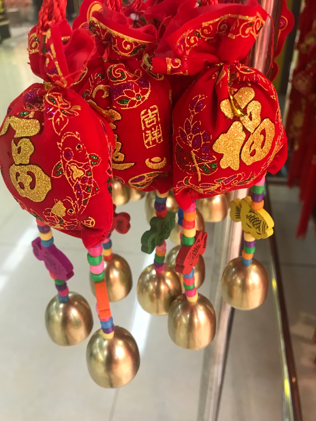 Two strings of bells with the character "Fu" printed on the money bag