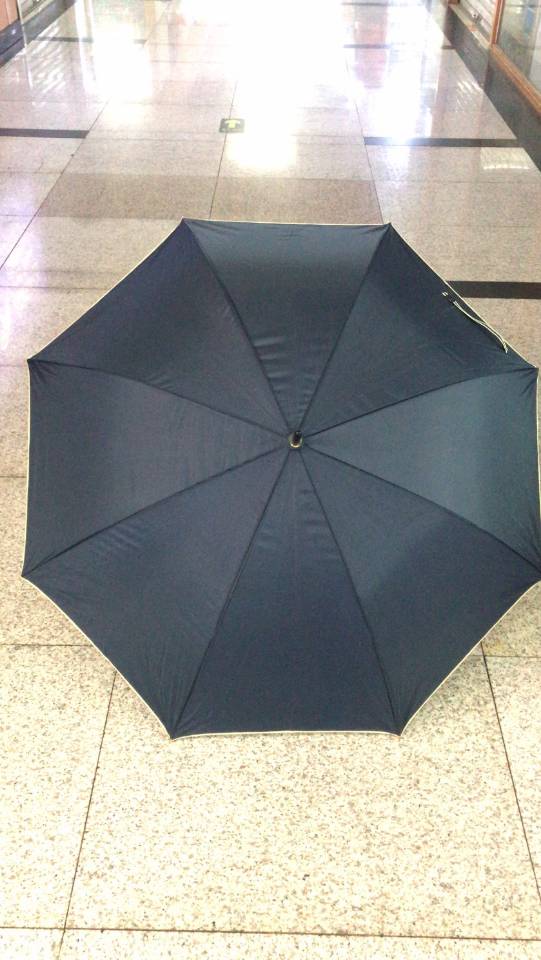 Close-up of water droplets rolling off umbrella fabric