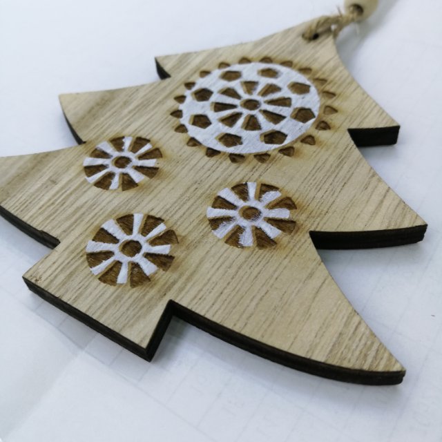 The wooden Christmas tree wall is decorated with kindergarten and primary school supplies details Picture