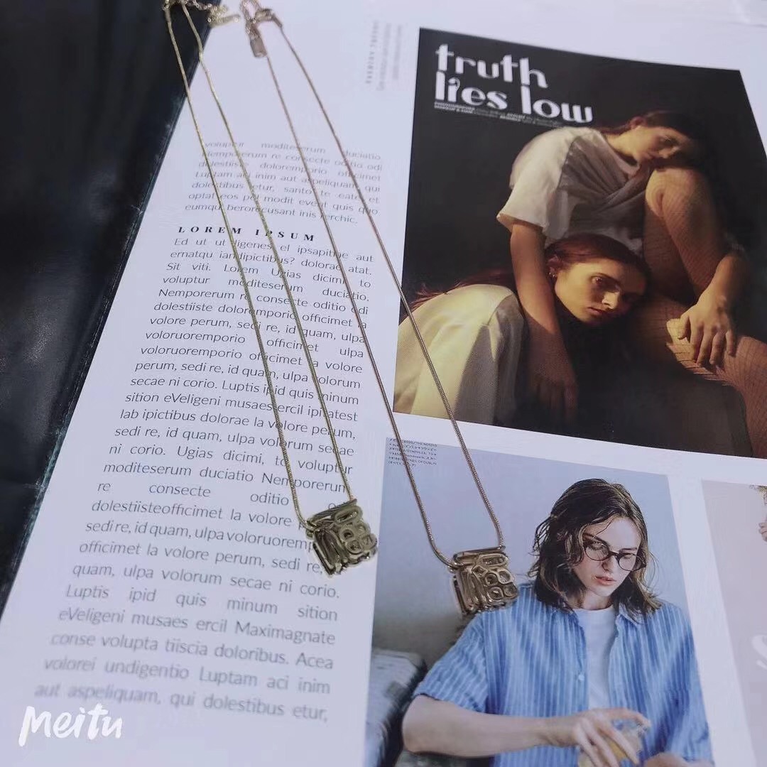 A fashionable necklace featuring a double-sided hollowed-out "Fu" character pendant with symbolic meaning